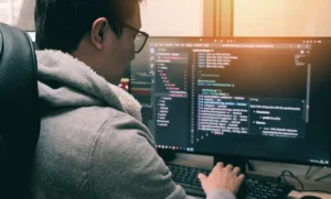 Software engineer working on code and system architecture in a modern workspace.